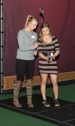 Sophia Popov and Kylie Drexel demonstrate the golf simulator.