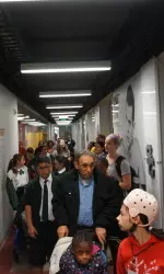 Athletes tour children through the basement of the John McKay Center.