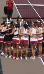 Middle school visitors join the huddle as the tennis team gears up for their match.