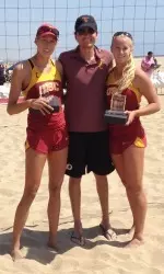 Kirby Burnham (left) and Sara Hughes accept their pairs championship trophy from tournament administrator Todd Davis.