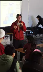 Coach Peter Smith speaks to children at Global Education Academy.