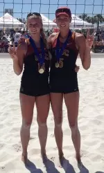 Sara Hughes (left) and Kirby Burnham with the AVCA pairs national championship medals.