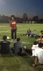 Coach McAlpine encourages neighborhood children.