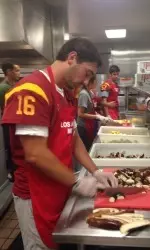 Senior Anthony Neyer prepares a meal with teamates at the LA Mission.