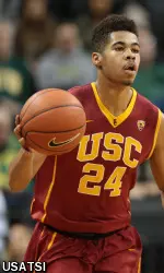 Malik Marquetti dribbles the ball down the court.