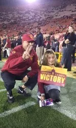 Head Coach Clay Helton meets with a Trojan Wish participant prior to the victory against Arizona.