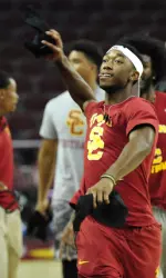 Freshman football player John Plattenburg prepares to toss a t-shirt into the stands full of Day in Troy participants at Galen Center on Sunday.