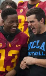 Trojan cornerback Kevon Seymour shares a laugh with Bruin fullback Taylor Lagace at 186th Street School.