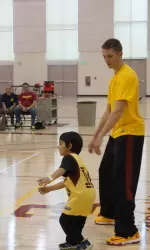 Sophomore guard Devon Pflueger instructs a young cub scout.