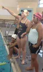Sophomore swimmer Jamie Christy instructs a group of students at Bethune Middle School.