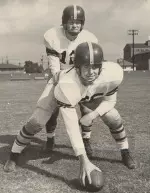 Ellsworth Kissinger taking a snap from USC teammate Mike Dowell.