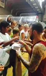 Game MVP Katin Reinhardt signs autographs for the fans, following his 33-point performance.