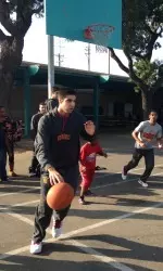 Dhillon plays basketball with kids during visit to local school
