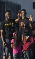 Trojan safety John Plattenburg and wide receiver Jalen Greene celebrate Super Bowl Spirit Day with kids at 186th St. School
