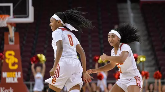 Shalexxus Aaron and Minyon Moore celebrate in another USC win.