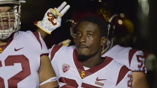Ajene Harris holds up the "V for Victory" sign.