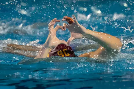 Zach D'Sa makes a heart sign after a big goal at the NCAA tournament.
