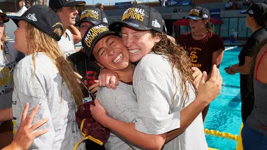 Alaina Cousineau and Courtney Fahey embrace on the pool deck after USC wins the 2018 NCAA Women's Water Polo Championship