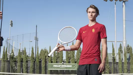 Senior Jens Sweaney poses with his racket at Marks Stadium