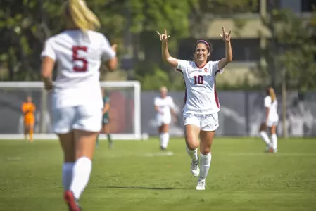 Savannah DeMelo and Penelope Hocking celebrate after a score