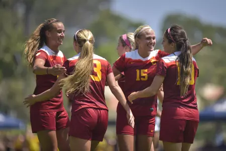 Trojan defenders chase after a loose ball