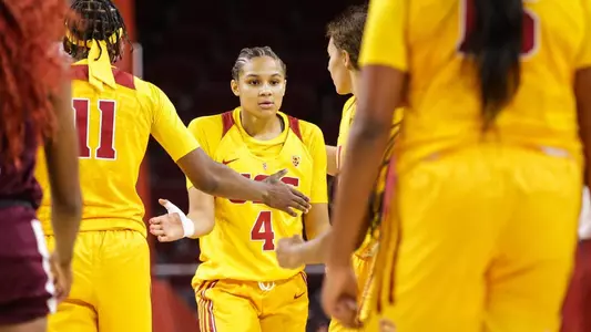 Endyia Rogers gets fives from her teammates in a game at Galen Center
