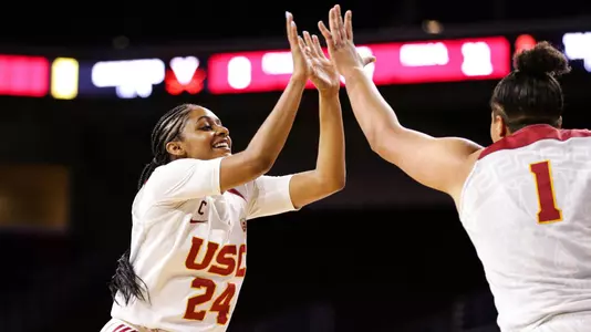 Desiree Caldwell and Kayla Overbeck give fives during a USC win at Galen Center