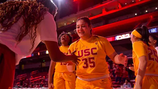 Alissa Pili gets a special handshake from Shalexxus Aaron during intros at Galen Center
