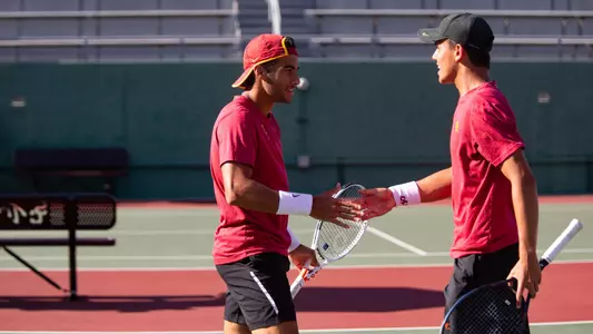 Daniel Cukierman and Bradley Frye give each other five in their doubles match at Marks Stadium