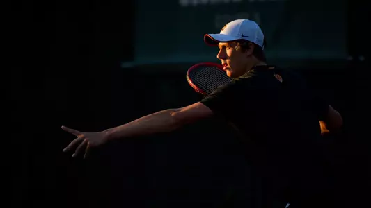 Riley Smith lines up a shot with the sunlight lighting him up at Mark Stadium