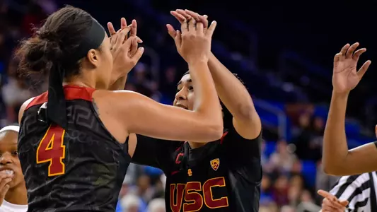 Sisters Mariya and Minyon Moore celebrate during USC's win at UCLA