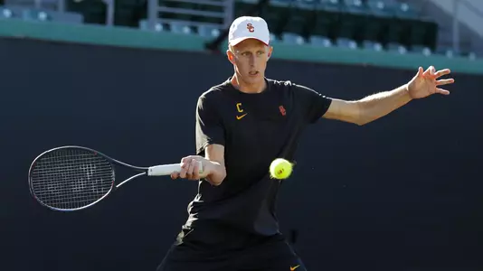 Tanner Smith swats a forehand in a match at Marks Stadium