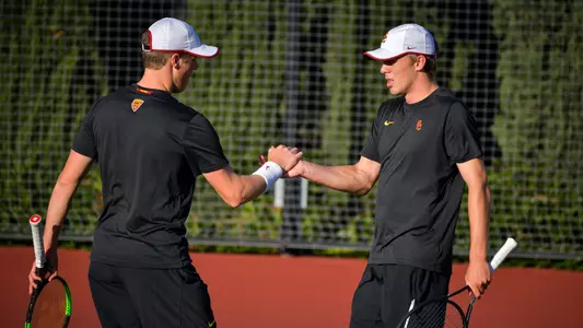 Laurens Verboven and Jack Jaede give each other five during a doubles match at Marks Stadium