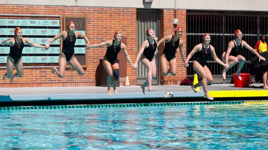 USC starters jump into the pool before a game at Uytengsu Aquatics Center.