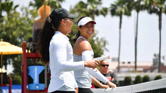 Angela Kulikov and Rianna Valdes smile while playing in the NCAA Tournament.