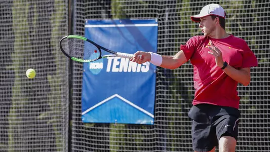 Brandon Holt rockets a forehand during NCAA team competition