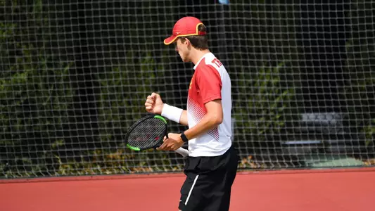 Brandon Holt cheers a point won in an NCAA Team Round of 16 singles match at Marks Stadium