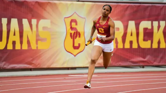 Bailey Lear running with baton