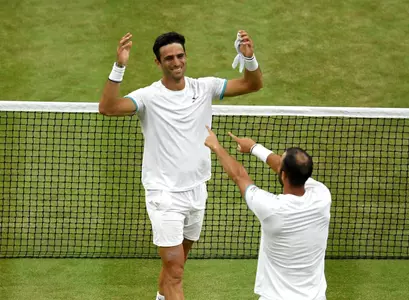 LONDON, ENGLAND - JULY 13: Sebastian Cabal of Colombia and playing partner Juan Robert Farah of Colombia celebrate match point in their Men's Doubles final against Nicolas Mahut of France and Edouard Roger-Vasselin of France during Day twelve of The Championships - Wimbledon 2019 at All England Lawn Tennis and Croquet Club on July 13, 2019 in London, England.