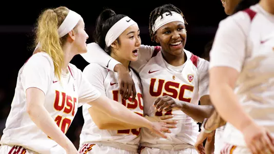 USC teammates congratulate Aliyah Jeune after a big basket vs. UCLA