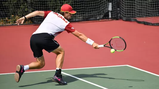 Brandon Holt stretches for a backhand return at Marks Stadium