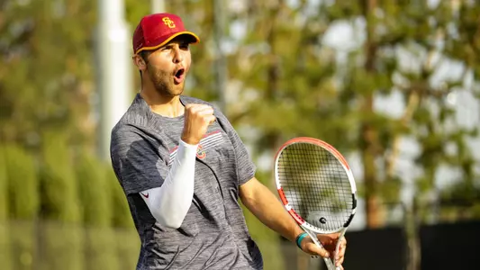 Stefan Dostanic celebrates a point won in his first dual-match as a Trojan