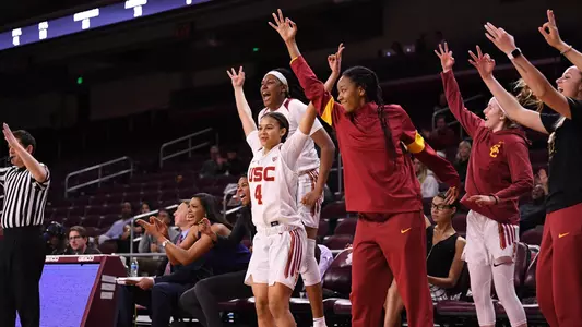 The bench celebrates a three in a win over WSU