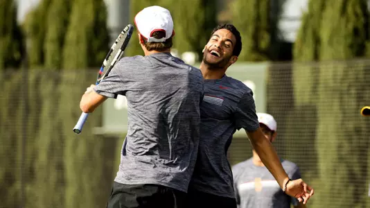 Daniel Cukierman and Riley Smith chest-bump during a doubles win at Marks Stadium