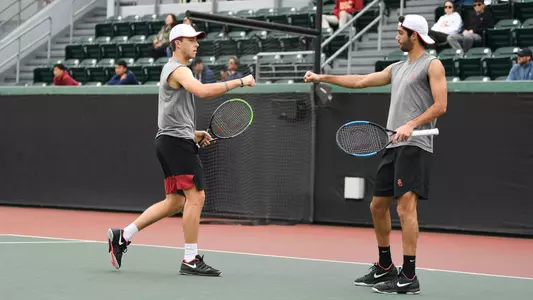 Brandon Holt and Mor Bulis fist-bump during doubles at Marks Stadium