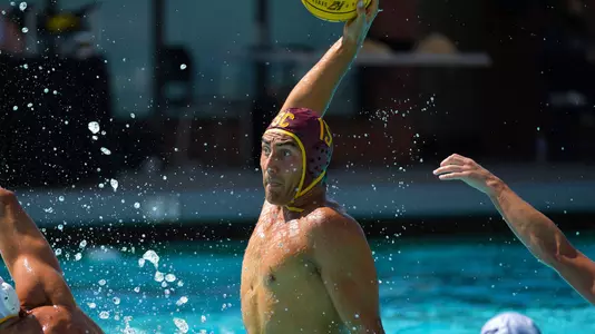 Wide-eyed Wyatt Barker rises up for a shot on goal at Uytengsu Aquatics Center
