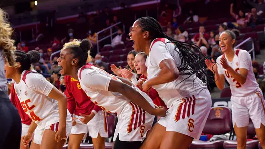 USC bench players cheer a big play at Galen Center