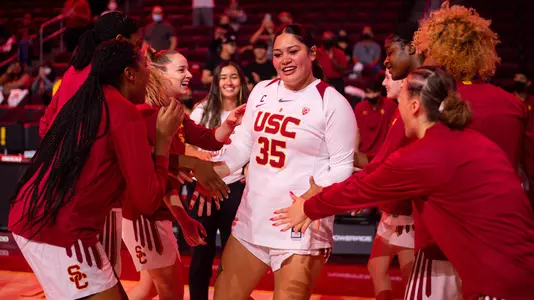 Teammates cheer Alissa Pili as she is announced during starting lineups at Galen Center