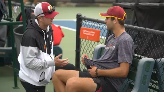 Brett Masi talks to Stefan Dostanic during a singles match at the ITA Fall Nationals