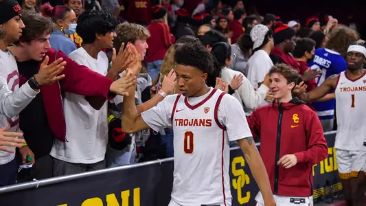 USC Basketball guard Boogie Ellis celebrates with Trojan Fever student section